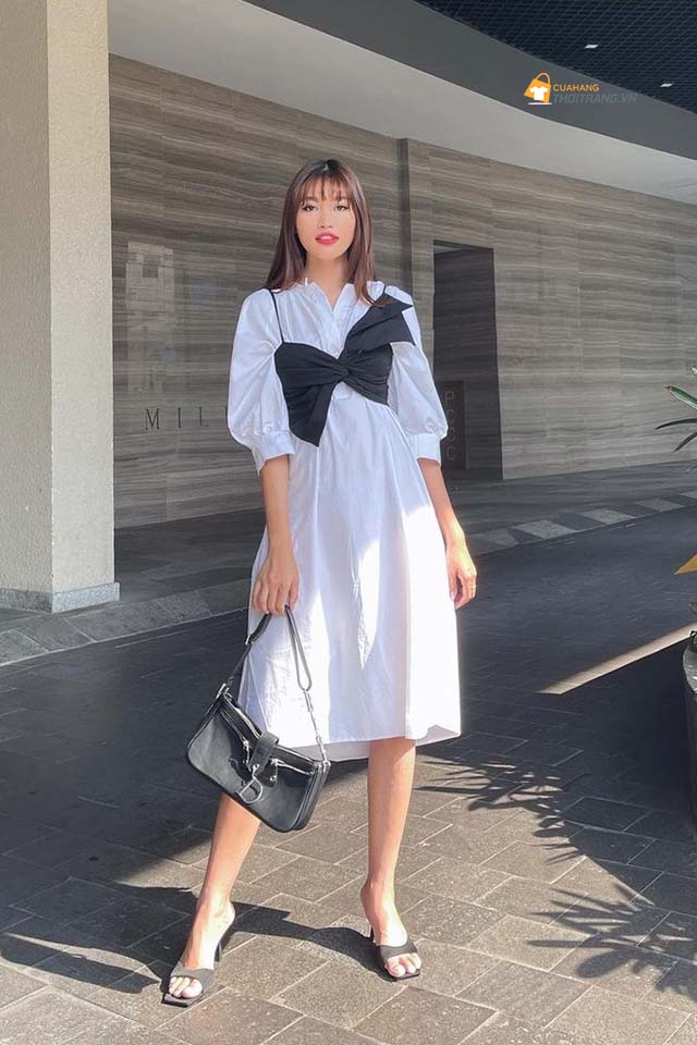 Quỳnh Châu nhờ mix đầm trắng với áo dây nơ, điểm phụ kiện tuyền đen mà ghi điểm ngoạn mục.